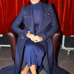 Monica Brown Wears A Chloé Long-Length Double-Breasted Coat And Tomas Maier Dress