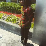 Wale Wears A Valentino Tie-Dye Shirt With Embroidered Butterflies, Amiri Jeans & Rick Owens Panelled Leather High Top Sneakers