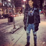 NBA Fashion: Willie Cauley Stein Styles In A Raf Simons Padded Coat, Alexander Wang Lighting Collage Sweatshirt & Amiri MX1 Medium Indigo Jeans With Black Leather Patches