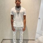 Nle Choppa Wears An Alexander McQueen Logo Embroidered T-Shirt, Burberry Graphic-Print Mulberry Silk Trousers And Dior B22 White Technical Mesh Sneakers