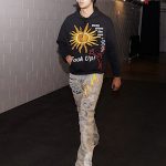 Kyle Kuzma Wears A Who Decides War Salutations Embroidered Sweatshirt And Sunshower Overlay Denim Jeans