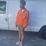 Rapper Nardo Wick Dressed In A Dior x Kenny Scharf Orange Shirt Jacket, Amiri Chemist Star Jeans And Dior B22 Sneakers