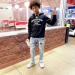 Mikey Williams Wears A Christian Dior Atelier Hoodie, Purple Brand P002 Mid Rise Slim Worn Jeans And Versace Chain Reaction Sneakers