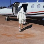 Flying In Style: Noah Neumannn Wears Fear Of God Essentials And Jordan 1 Retro High Trophy Room Chicago Sneakers While Boarding A Private Jet