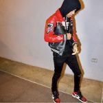 Rapper Nardo Wick Dressed In An Avirex Tuskegee Leather Bomber Jacket, Amiri Black Broken Skinny Jeans & Air Jordan 1 Retro High Bred Toe Sneakers